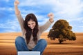 Brunette cheering while using laptop Royalty Free Stock Photo