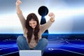 Brunette cheering while using laptop Royalty Free Stock Photo
