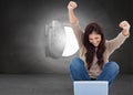 Brunette cheering while using laptop Royalty Free Stock Photo