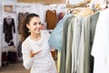 Brunette choosing skirt in shop Royalty Free Stock Photo