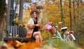 Brunette with coffee is resting on bench in park. Royalty Free Stock Photo