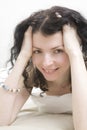 Brunette curl woman lying on bed