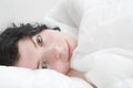 Brunette curl woman lying on bed