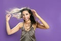 Brunette dancing at studio on purple background Royalty Free Stock Photo