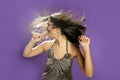 Brunette dancing at studio on purple background Royalty Free Stock Photo