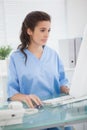 Brunette doctor using mouse of computer Royalty Free Stock Photo