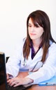 Brunette doctor working with a laptop in hospital Royalty Free Stock Photo