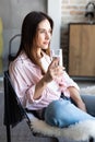 Brunette woman drinking water in the living room Royalty Free Stock Photo