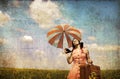 Brunette enchantress with umbrella and suitcase Royalty Free Stock Photo