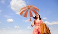 Brunette enchantress with umbrella and suitcase Royalty Free Stock Photo