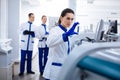 Brunette focused researcher scrutinizing sample attentively