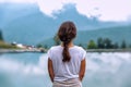 A brunette girl back. Mountain landscape. Clouds reflection. Krasnaya polyana Sochi Russia