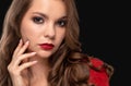 Brunette girl with beautiful makeup, with clean skin, long curly hair wearing a red dress Royalty Free Stock Photo