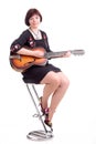 brunette girl in black dress play guitar Royalty Free Stock Photo