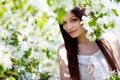 Brunette girl in blossom garden