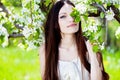 Brunette girl in blossom garden