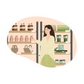 Brunette girl choosing organic bodycare products in cosmetics store