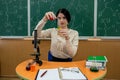 brunette girl conducts a master class in chemistry with flasks in a chemical office. Royalty Free Stock Photo