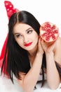 Brunette girl with garnet fruit in studio Royalty Free Stock Photo