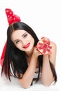 Brunette girl with garnet fruit in studio Royalty Free Stock Photo