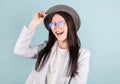 Brunette girl with gray hat in white t-shirt dancing with inspired face expression