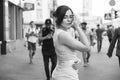 Brunette girl in grey smark casual dress walking in european city. She look sad. copy space Royalty Free Stock Photo