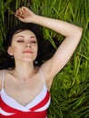 Brunette girl jumping in summer field