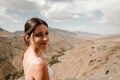 Brunette girl looking at camera with the high atlas in the background Royalty Free Stock Photo