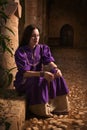 Brunette girl in a medieval suit in a Agia Napa Medieval Monastery