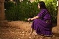 Brunette girl in a medieval suit in a Agia Napa Medieval Monastery