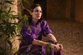 Brunette girl in a medieval suit in a Agia Napa Medieval Monastery