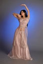 Brunette girl in oriental dress on a blue background in the studio Royalty Free Stock Photo