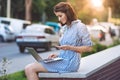 Brunette girl with phone and laptop