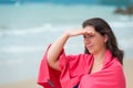 brunette girl in a pink towel on the beach Royalty Free Stock Photo