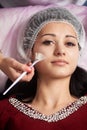 Brunette girl receiving treatments in beauty salons. Close-up