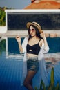 Brunette girl relaxing at the pool Royalty Free Stock Photo