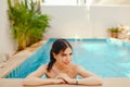 Brunette girl relaxing in the pool Royalty Free Stock Photo