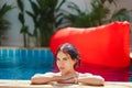 Brunette girl relaxing in the pool Royalty Free Stock Photo