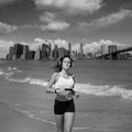 Brunette girl running in New York Brooklyn bridge Royalty Free Stock Photo