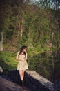 Brunette girl stands on the bridge near the water Royalty Free Stock Photo