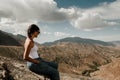 Brunette girl with sunglasses looking towards the valley of the high atlas Royalty Free Stock Photo