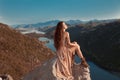 Brunette girl tourist in beige dress sightseeing of Rijeka Crnojevica, Montenegro. Skadar lake national park, Pavlova Strana. Vie