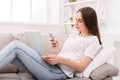 Young girl with a laptop messaging on mobile Royalty Free Stock Photo