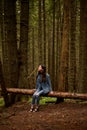 Brunette girl walking on the woods, traveler in romanian carpathian mountains, looking up. Vertical view