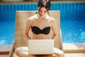 Brunette girl working by the pool Royalty Free Stock Photo