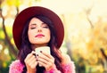 Girl wtih cup of coffee in the autumn park. Royalty Free Stock Photo