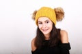 Brunette girl in in yellow cap with brown bobbles Royalty Free Stock Photo