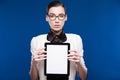 Brunette in glasses with a tablet in hands Royalty Free Stock Photo