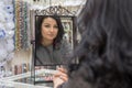 Brunette with green eyes admires herself in the mirror Royalty Free Stock Photo