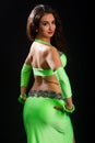 Brunette in a green suit oriental dance Royalty Free Stock Photo